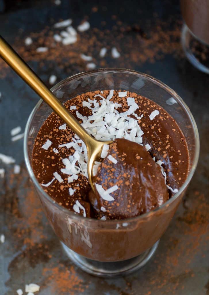 Spoonful of homemade chocolate pudding with coconut flakes