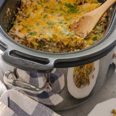 Salsa Verde Chicken and Rice in crockpot with wooden spoon